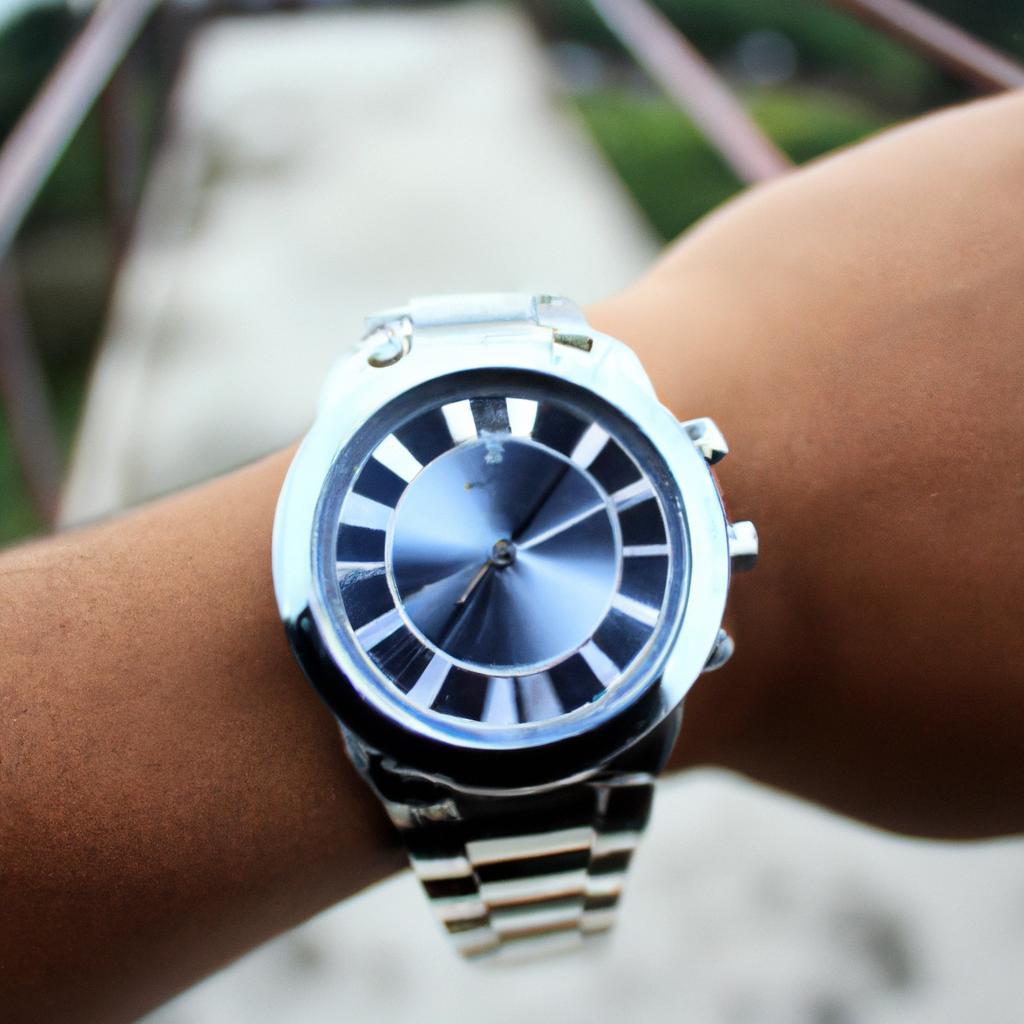 Person holding stainless steel watch