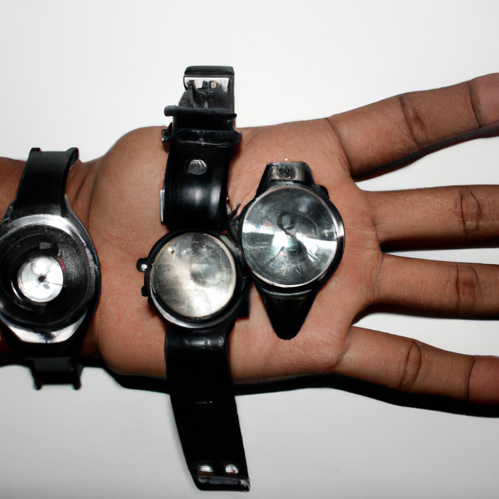 Person holding different sized watches